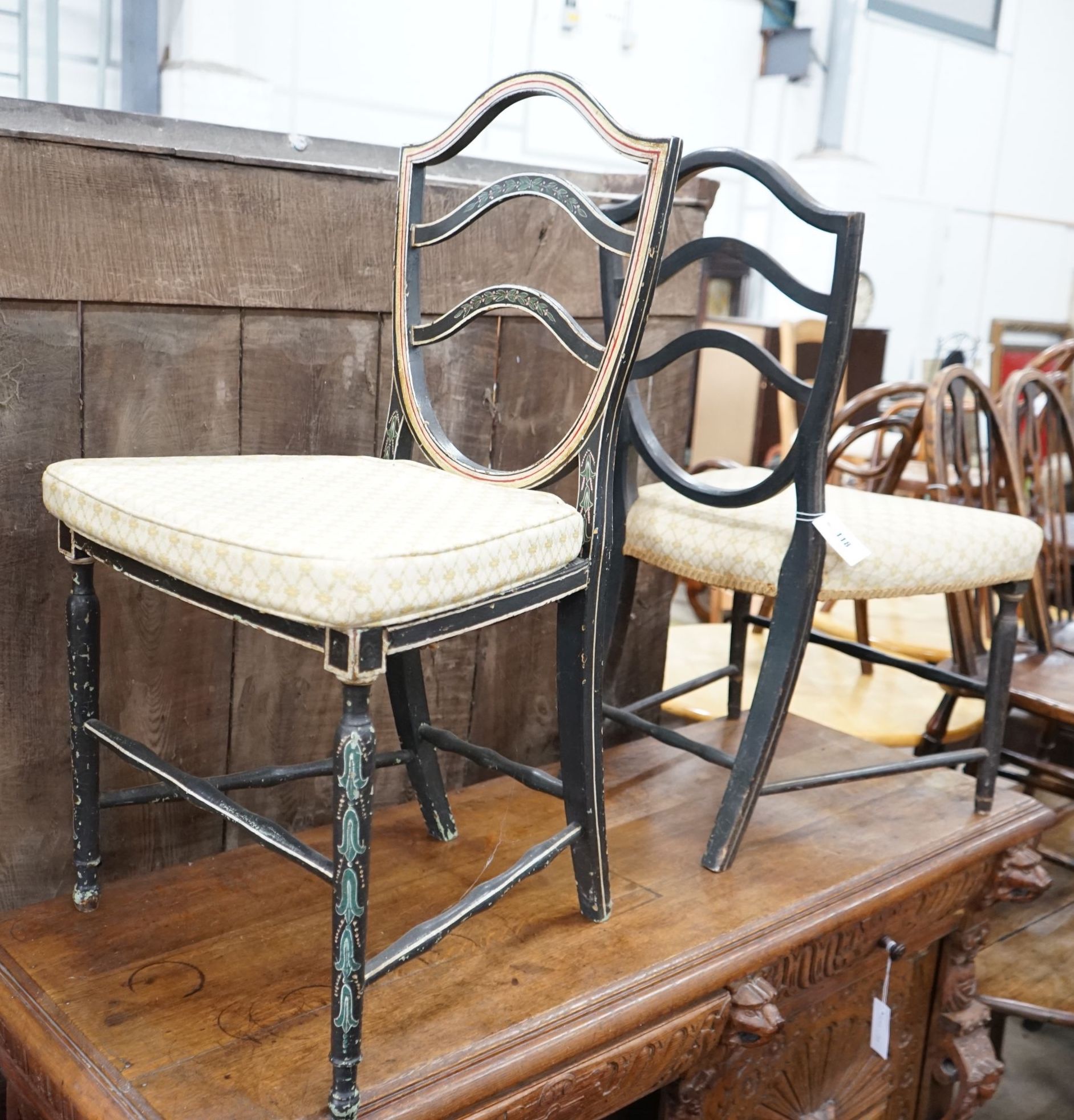A George III provincial painted cane seat chair and another